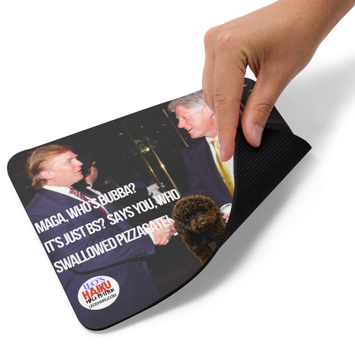 A hand picks up the lower right edge of a standard mouse pad printed with Bill Clinton and Donald Trump in suits with a dog between them, shake hands at an event. Features political, satirical, anti-MAGA haiku and text logo for leoshaiku.com at the bottom.