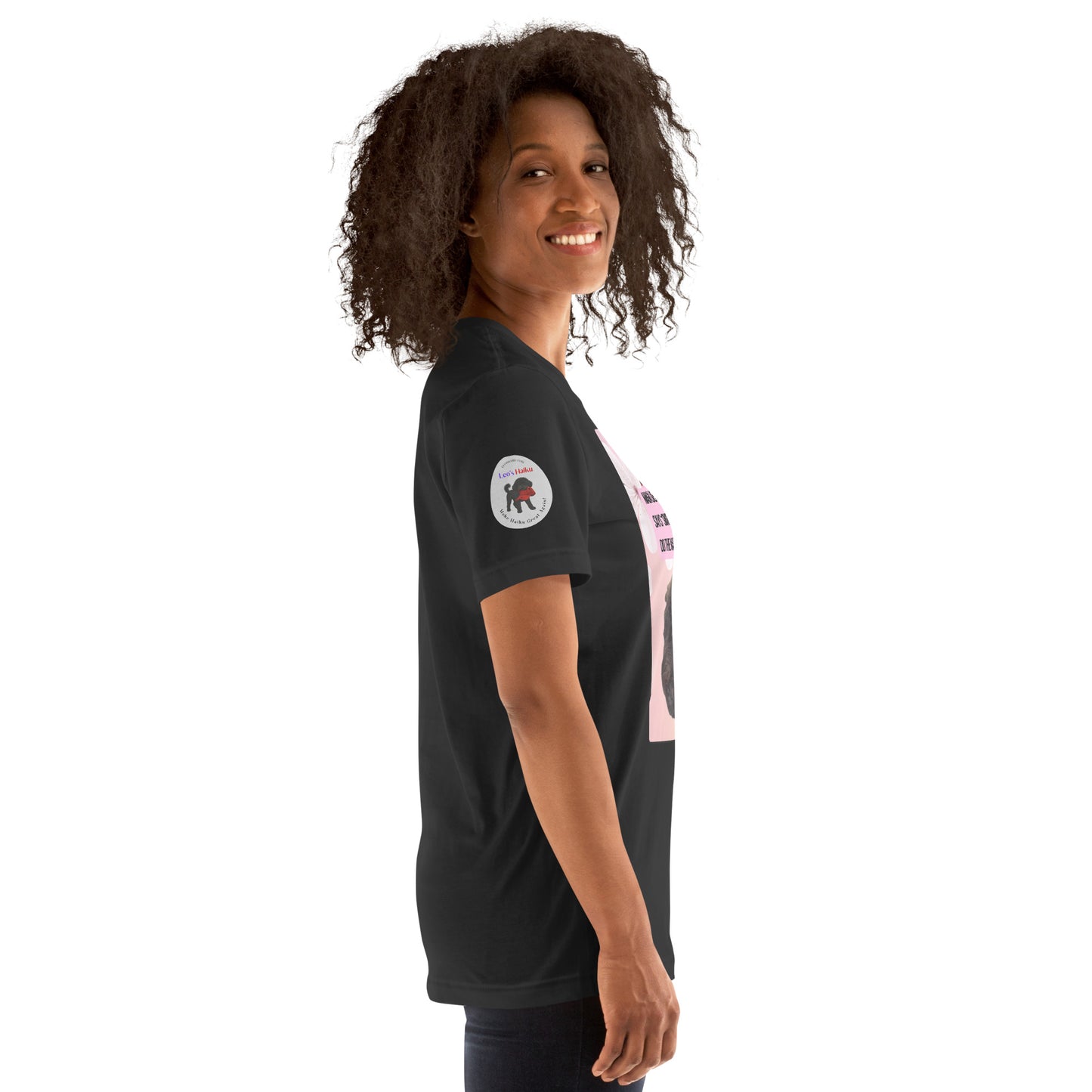Right side view of a woman wearing a dark gray t-shirt with the Leo's Haiku logo. Top of logo says leoshaiku.com; beneath that it says Leo's Haiku in Leo's colors of purple and red. Then Leo stands with a chewed red cap in his mouth. Beneath that image is reads Make Haiku Great Again.