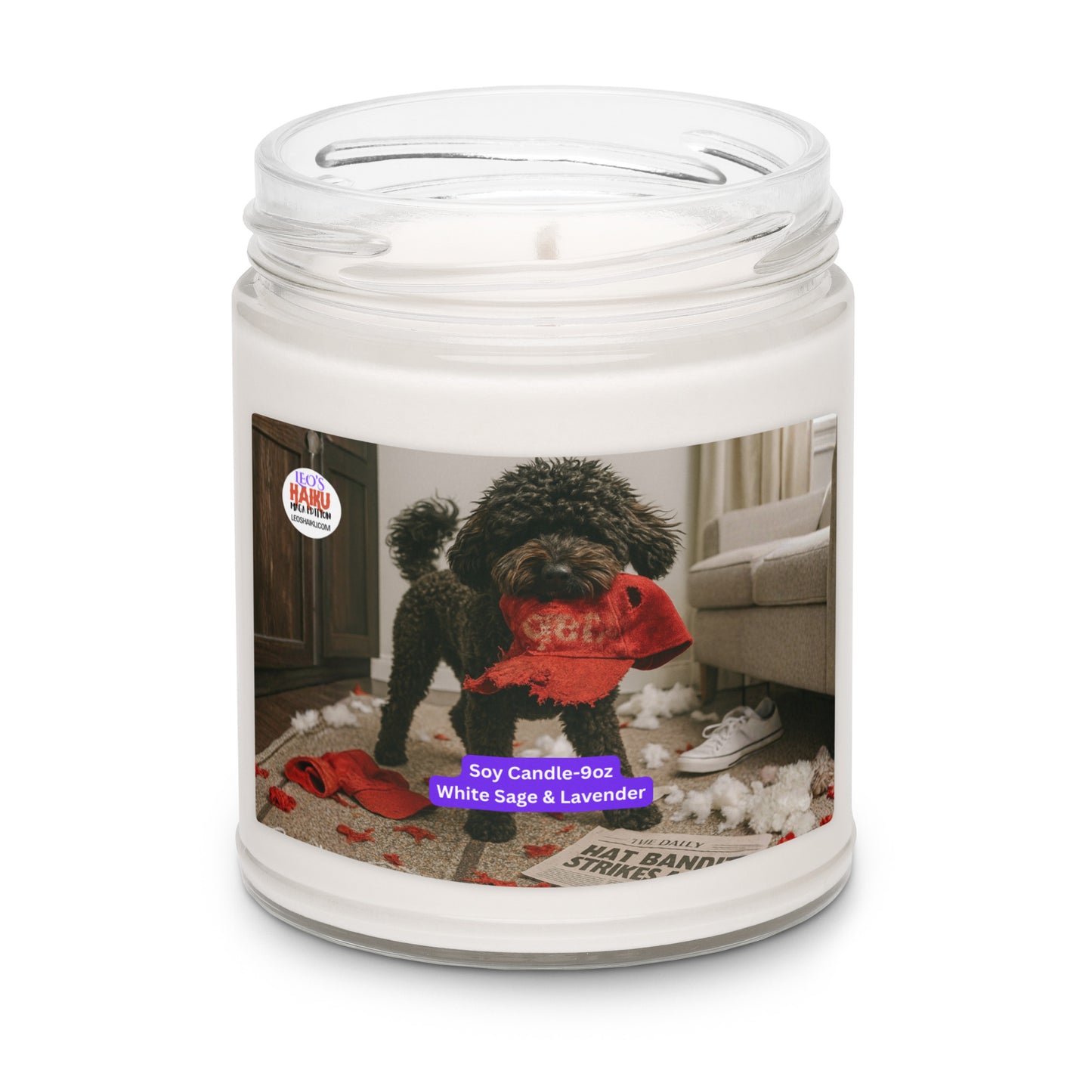 Candle in Glass jar. Label has the picture of a small black dog in the middle of a living room where he has been chewing up things. He has a chewed red hat in his mouth. To his left is the text logo for leoshaiku.com Bottom center front is a white text with a purple background that says Soy Candle - 9oz White Sage & Lavender