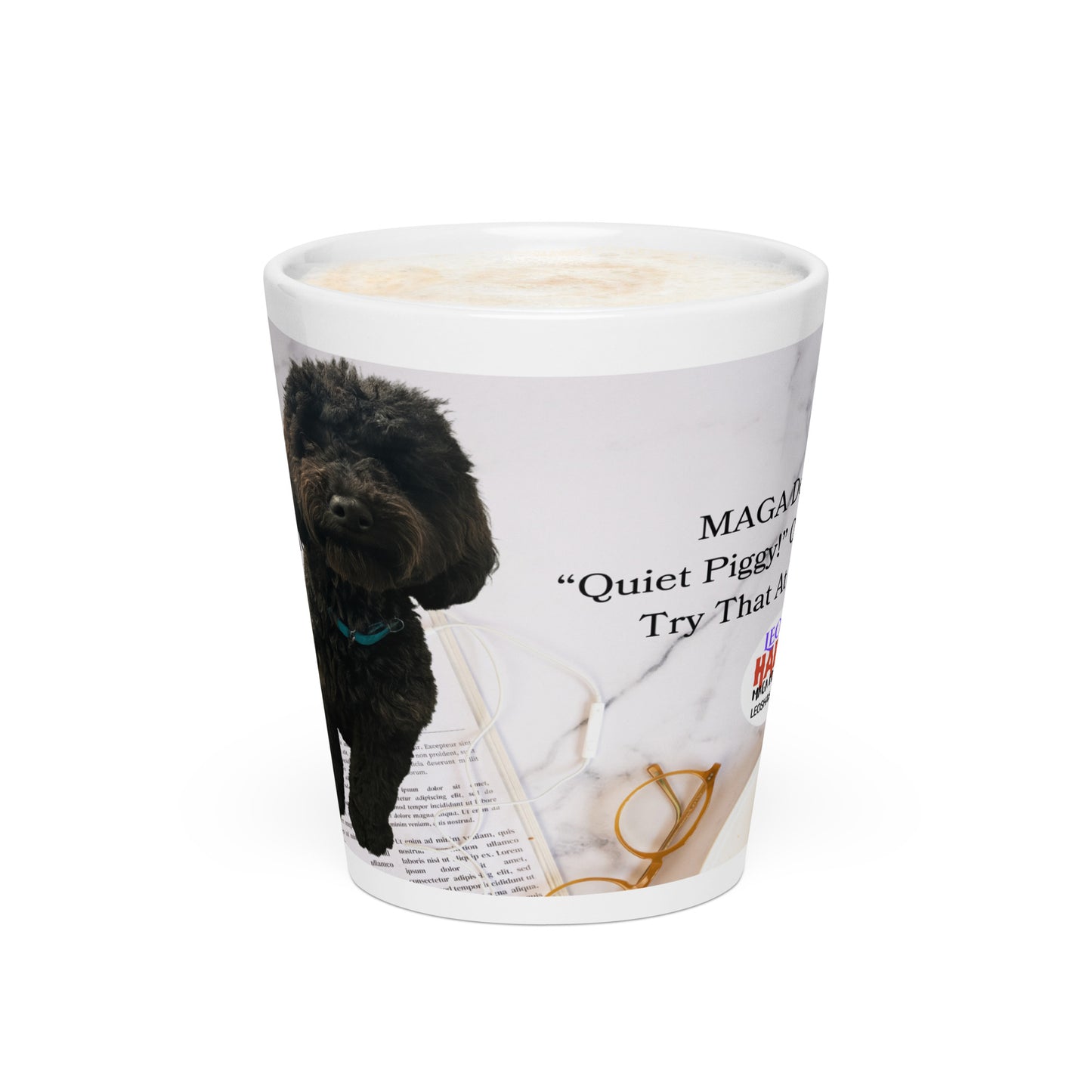White glossy ceramic mug is printed with a "kitchen counter" background showing a newspaper, eye glasses, and partial image of Leo, the black poodle.  Political, satirical, anti-MAGA haiku is partially shown.  Text logo for leoshaiku.com is also partially displaed.