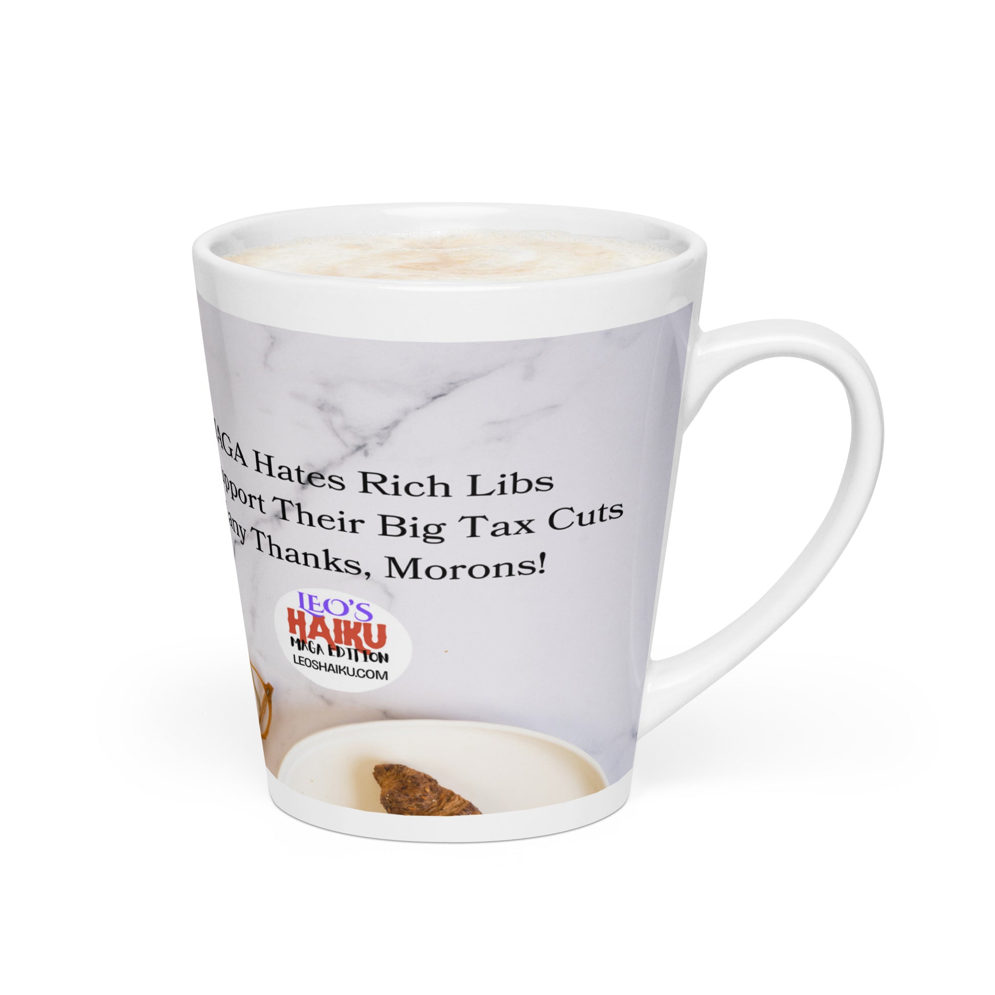White glossy ceramic mug with a white marble background and a plate with a croissant in the foreground.  Political, satirical, anti-MAGA haiku partially shown.   Text logo for leoshaiku.com is fully displayed.