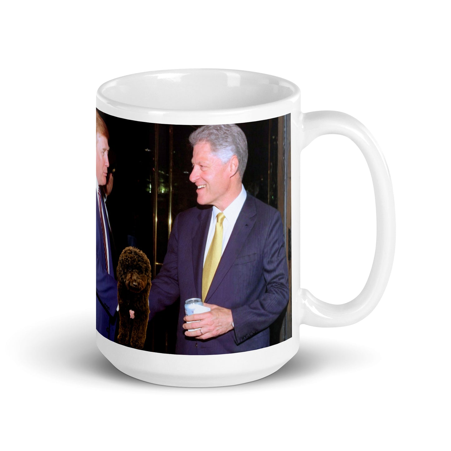 White glossy ceramic mug printed with Donald Trump and Bill Clinton shaking hands at an event.  Small black dog is between them.
