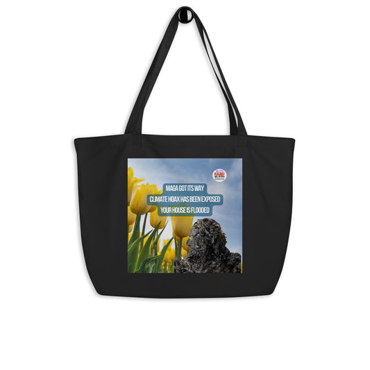 Large Black tote hung from a knob, printed with an image of a black dog in a field of tulips.  Centered above the dog is a political, satirical, anti-MAGA haiku that reads:
MAGA Got Its Way
Climate Hoax Has Been Exposed
Your House is Flooded
the circular text logo for leoshaiku.com is top right.