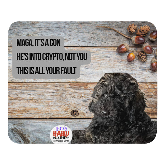 Standard Mouse Pad with an image of Leo the Black Mini Poodle top left against a wooden background.  Acorns and pine cones top right with the round text logo for leoshaiku.com below.  Centered is a political, satirical, anti-MAGA haiku that reads:  MAGA, It's a Con
He's Into Crypto, Not You
This is All Your Fault
