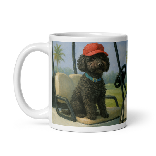 White glossy Ceramic Mug with a dog wearing a red cap and blue collar on a golfcart with a palm tree in the background.  Handle is on the left