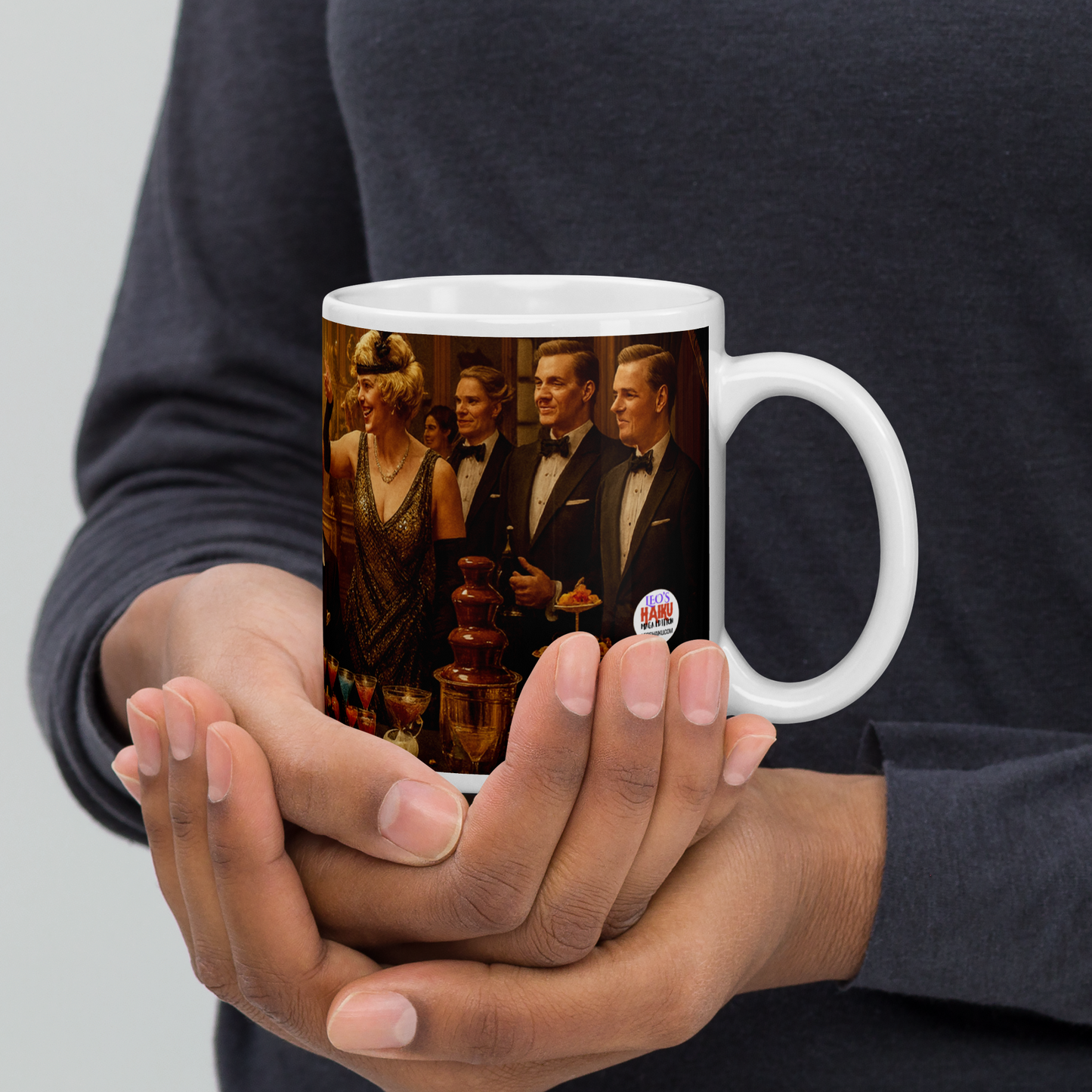 Person holding a mug with a printed design of people in formal attire for Gatsby Party.  Text Logo or Leo's Haiku also appears.