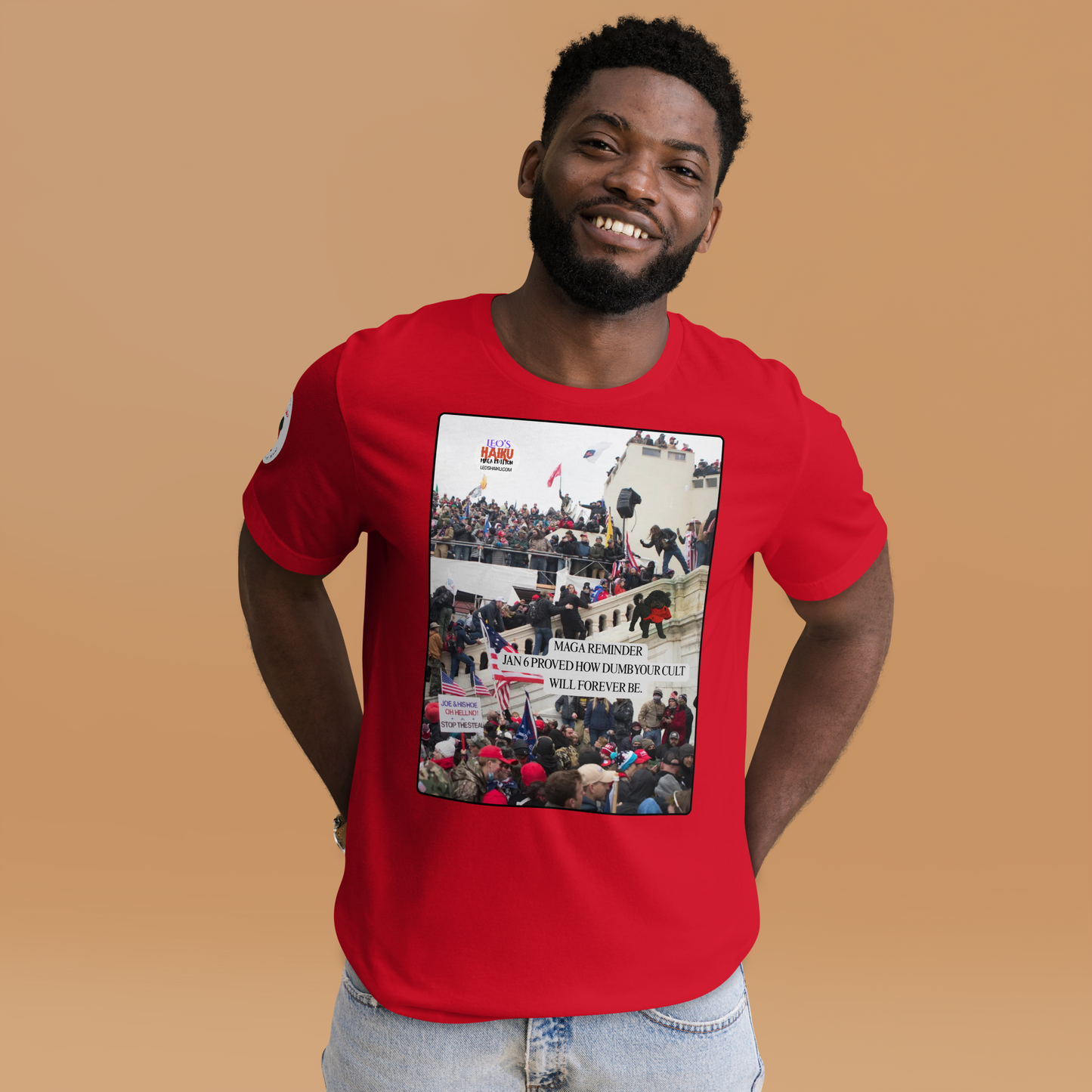 Man wearing a red t-shirt with a graphic design showing actual phone of the Jan 6 Insurrection at the US capital.  Leo with a chewed red cap is mid right; the circular text logo of leoshaiku.com is upper left.