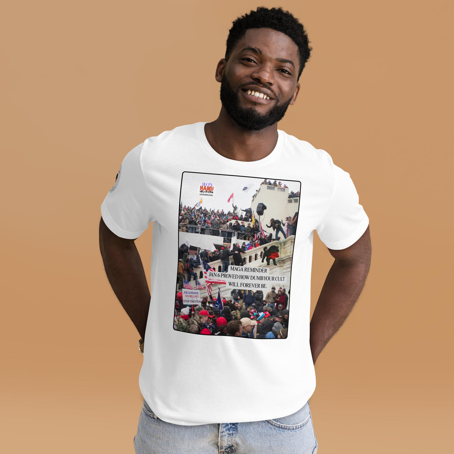 Man wearing a white t-shirt with a graphic design showing actual phone of the Jan 6 Insurrection at the US capital.  Leo with a chewed red cap is mid right; the circular text logo of leoshaiku.com is upper left.