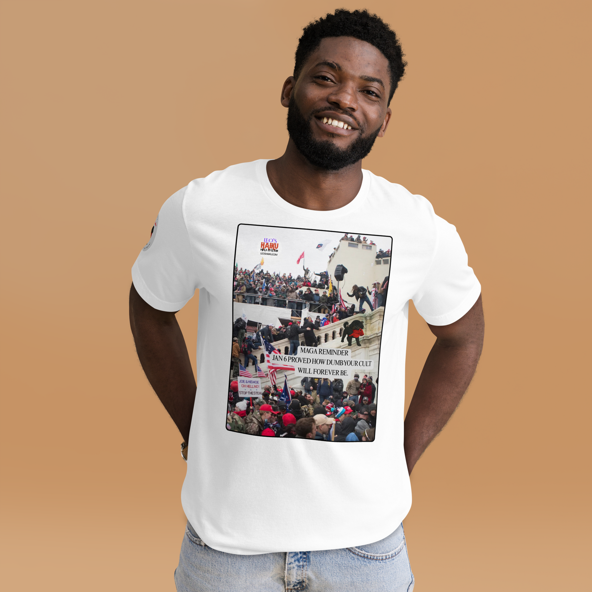 Man wearing a white t-shirt with a graphic design showing actual phone of the Jan 6 Insurrection at the US capital.  Leo with a chewed red cap is mid right; the circular text logo of leoshaiku.com is upper left.