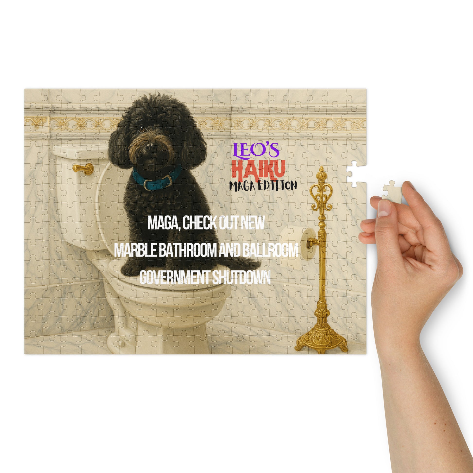 A glossy 252-piect jigsaw puzzle printed with a black dog sitting on a toilet seat in a very ornate marble and gold bathroom.  Text is political satire in haiku format; branding included.  At the right of the image, a woman's hand hold the last piece of the puzzle