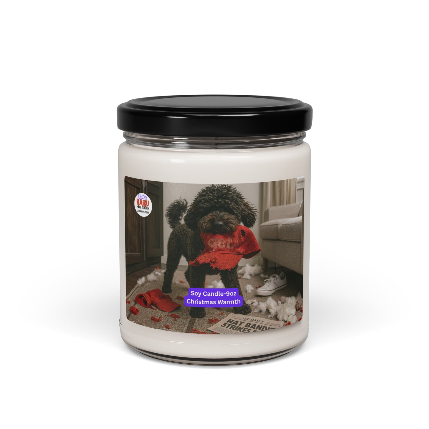 Candle in Glass jar with black metal lid.  Label has the picture of a small black dog in the middle of a living room where he has been chewing up things.  He has a chewed red hat in his mouth. To his left is the text logo for leoshaiku.com  Bottom center front is a white text with a purple background that says Soy Candle - 9oz Christmas Warmth