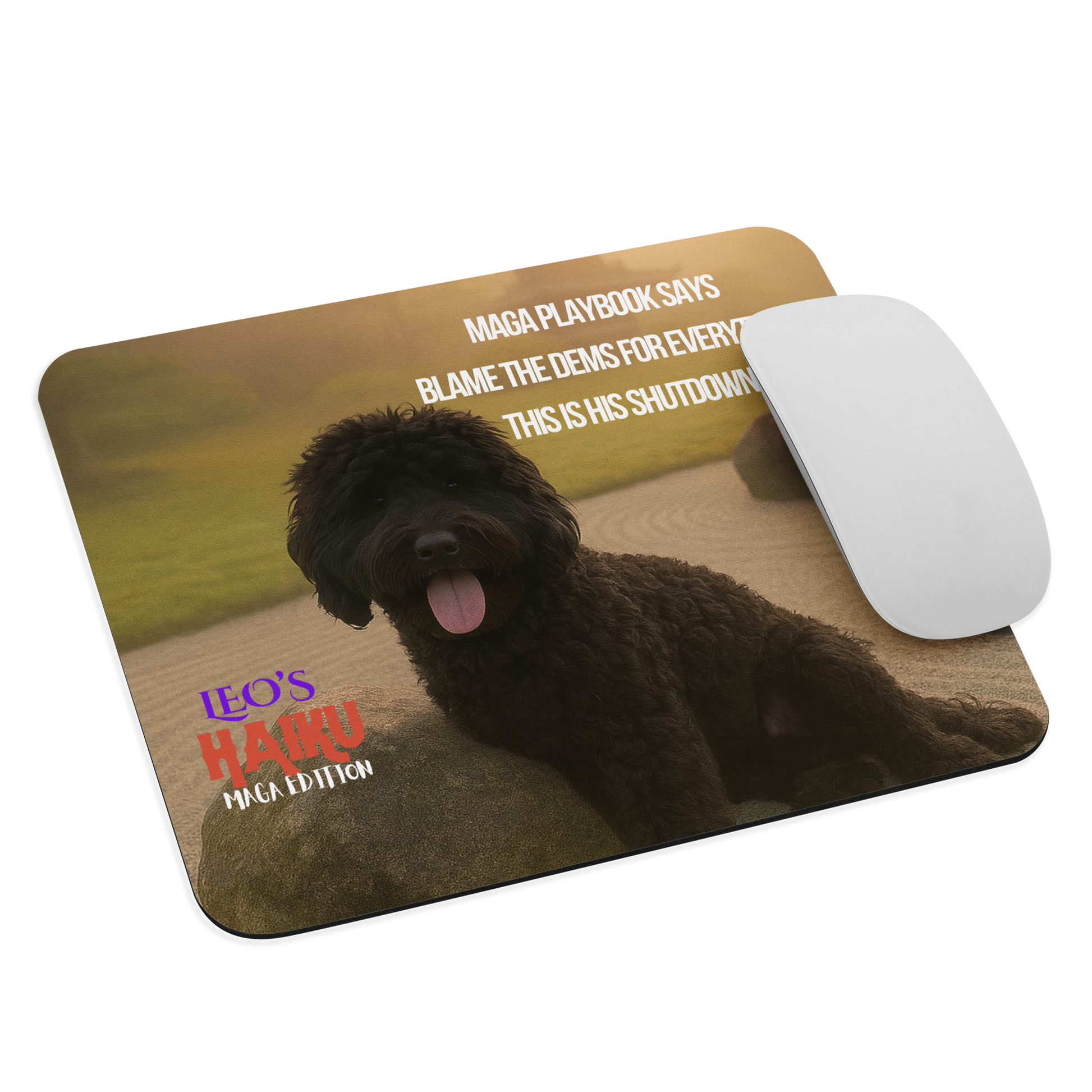 Standard-sized mouse pad printed with a Zen garden in golden light.  Poodle leans on rock beneath a Haiku of political satire.  A computer mouse sits on the right side of the pad.