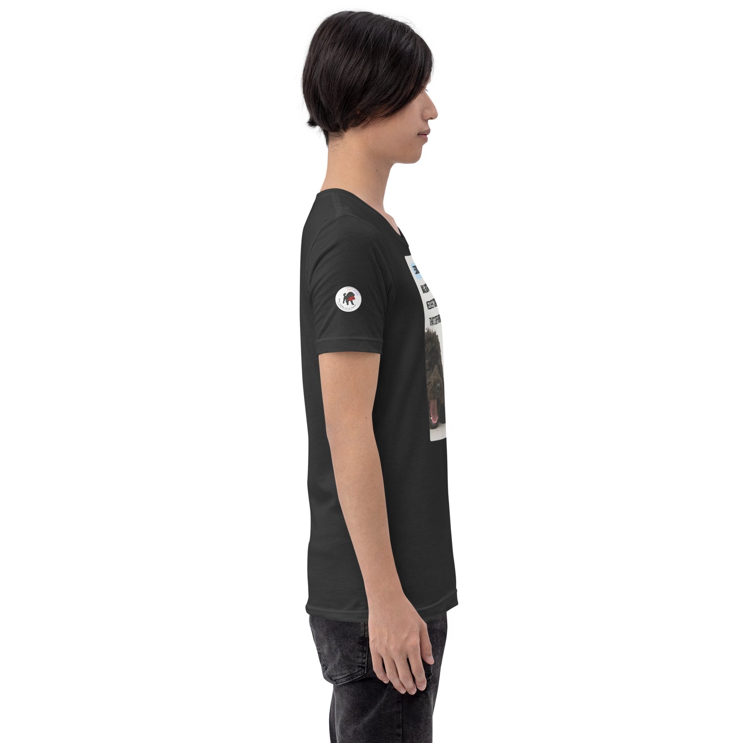  Young man in dark grey t-shirt facing right.  White logo on right sleeve.