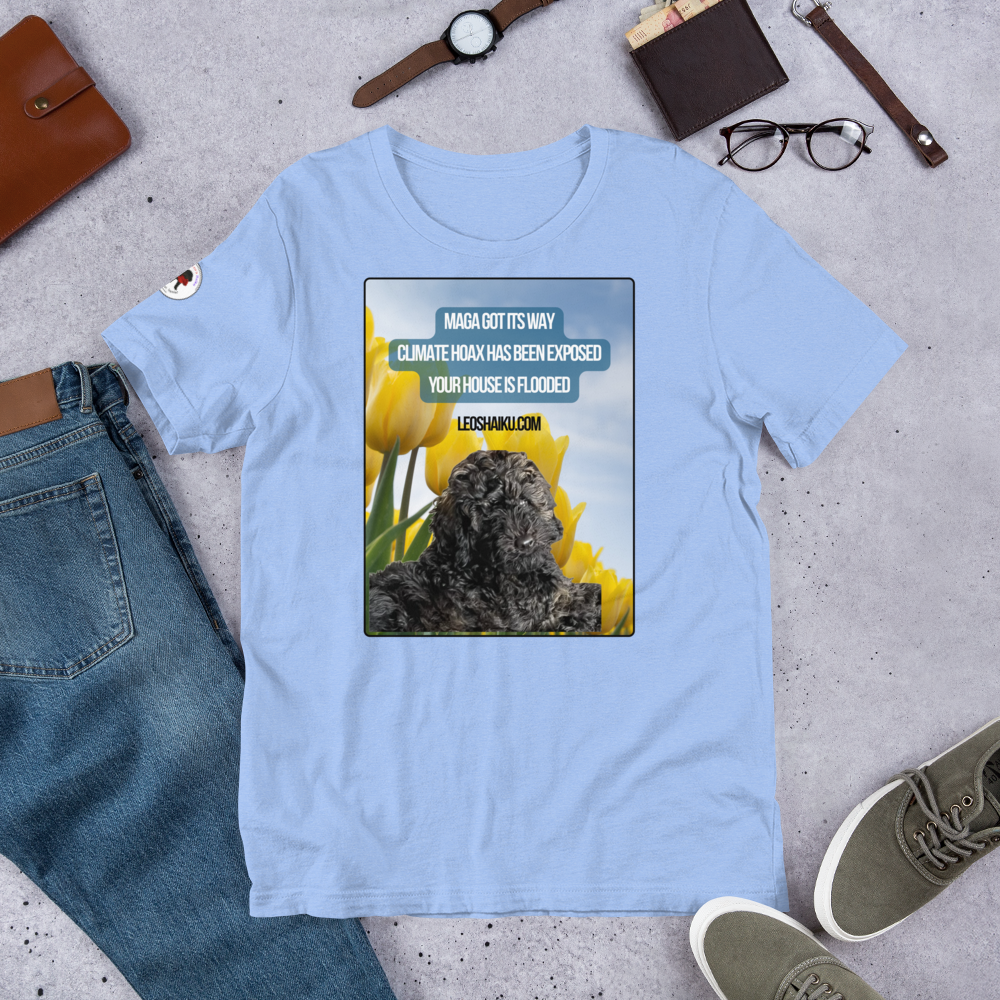 Carolina Blue t-shirt surrounding by jeans, shoes, glasses, watch.  T-shirt is printed with the image of a black dog in a field of yellow tulips.  A political, satirical, anti-MAGA haiku reads:
MAGA Got Its Way
Climate Hoas Has Been Exposed
Your House is Flooded!
Centered below it reads Leoshaiku.com