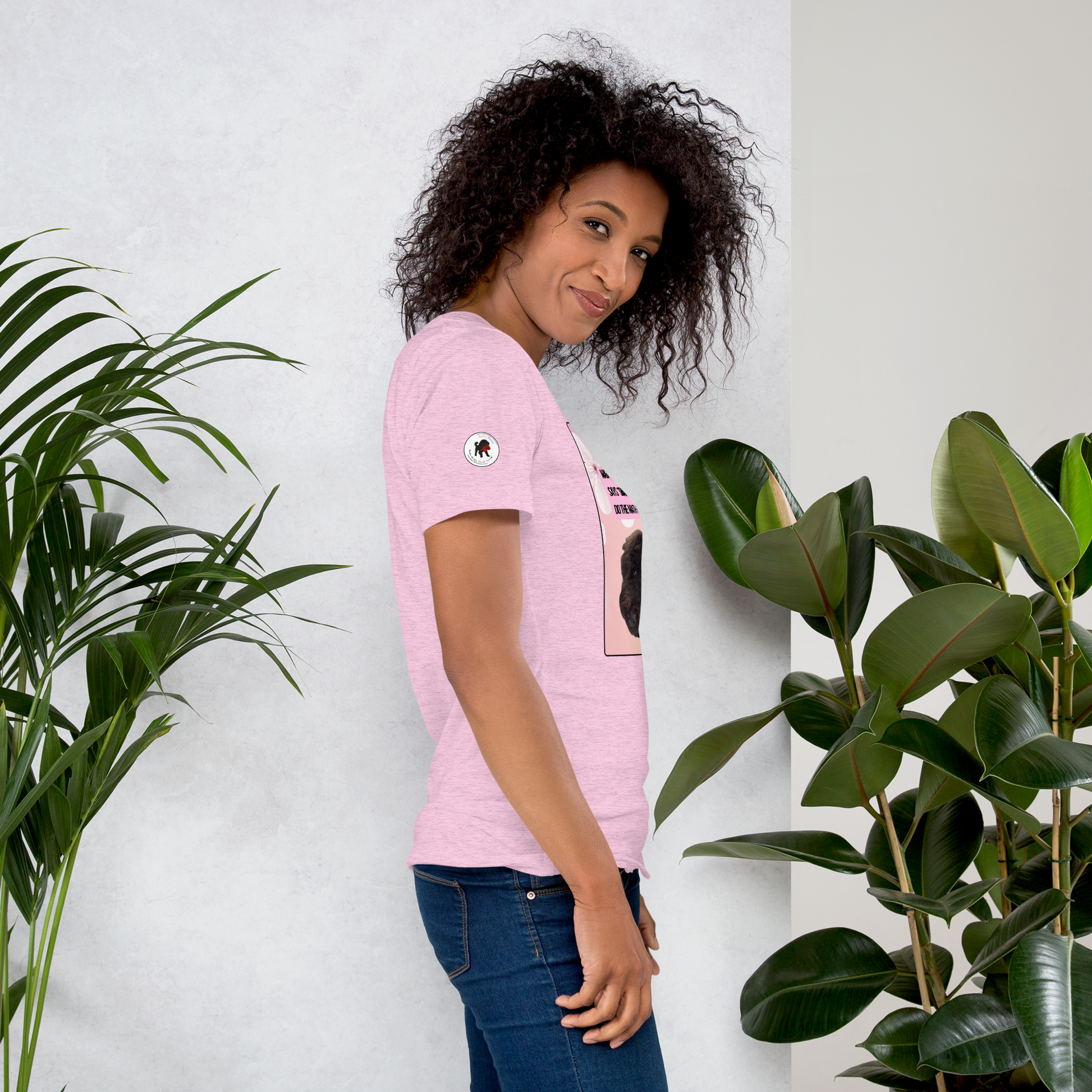 Young woman wearing a heather prism lilac t-shirt, facing right.  On the right sleeve is the logo for LEOSHAIKU.COM