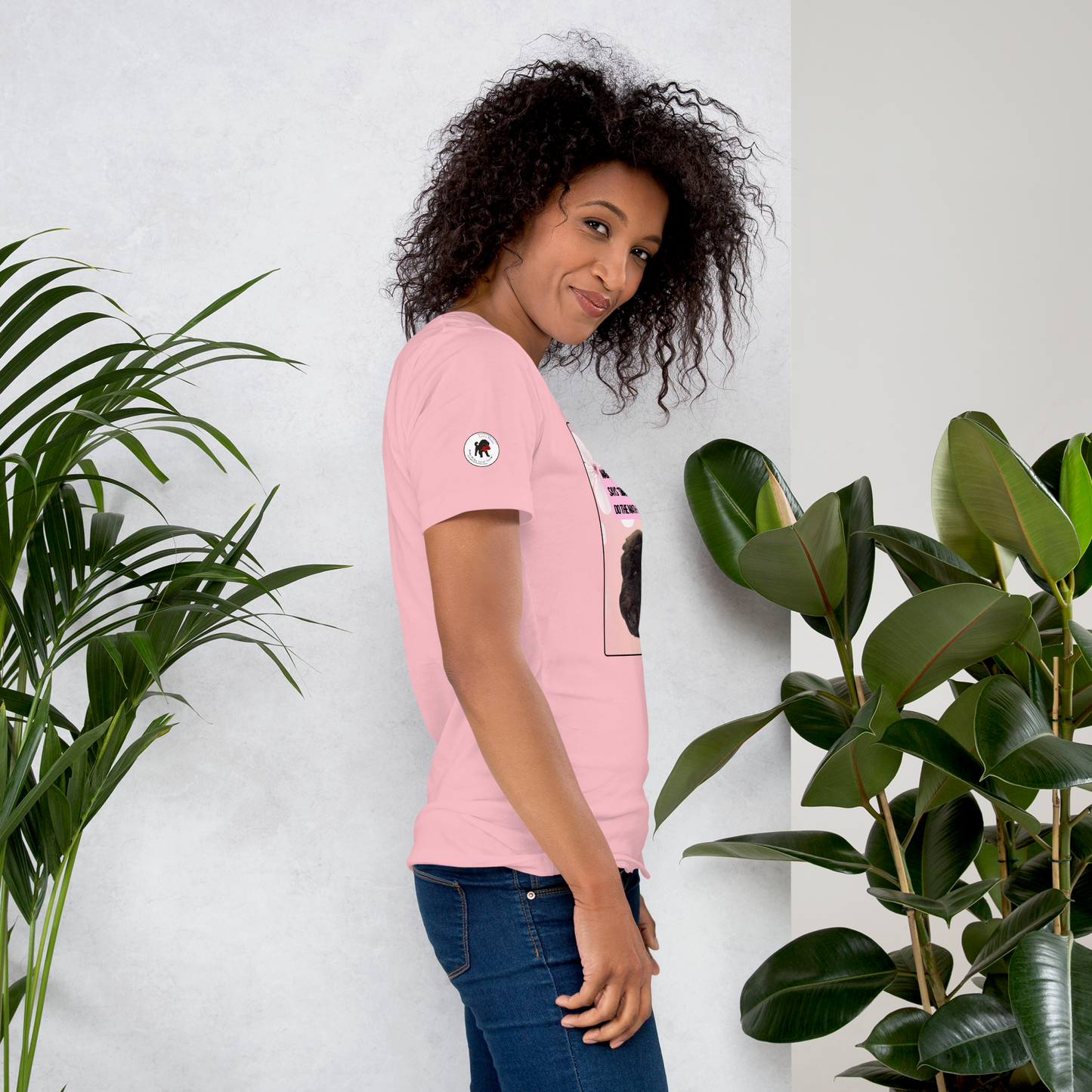 Young woman wearing a pink t-shirt, facing right.  On the right sleeve is the logo for LEOSHAIKU.COM