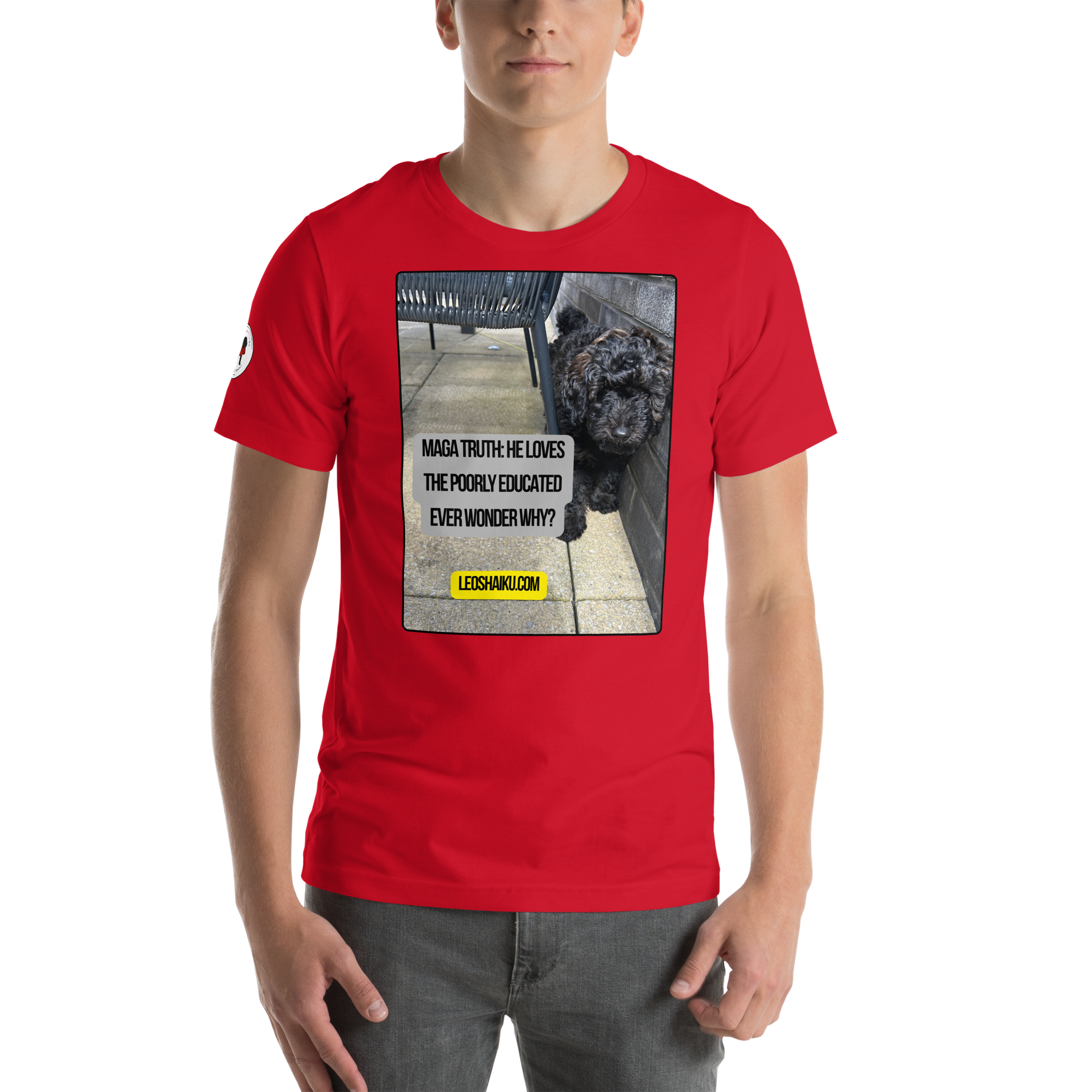 Young man in a red t-shirt facing front. Shirt is printed with the image of a dog huddled against an outside patio wall.  A political, satirical, anti-maga haiku reads:
MAGA Truth:  He Loves
The Poorly Educated
Ever Wonder Why?
centered below that in black letters on a yellow field, it reads LEOSHAIKU.COM