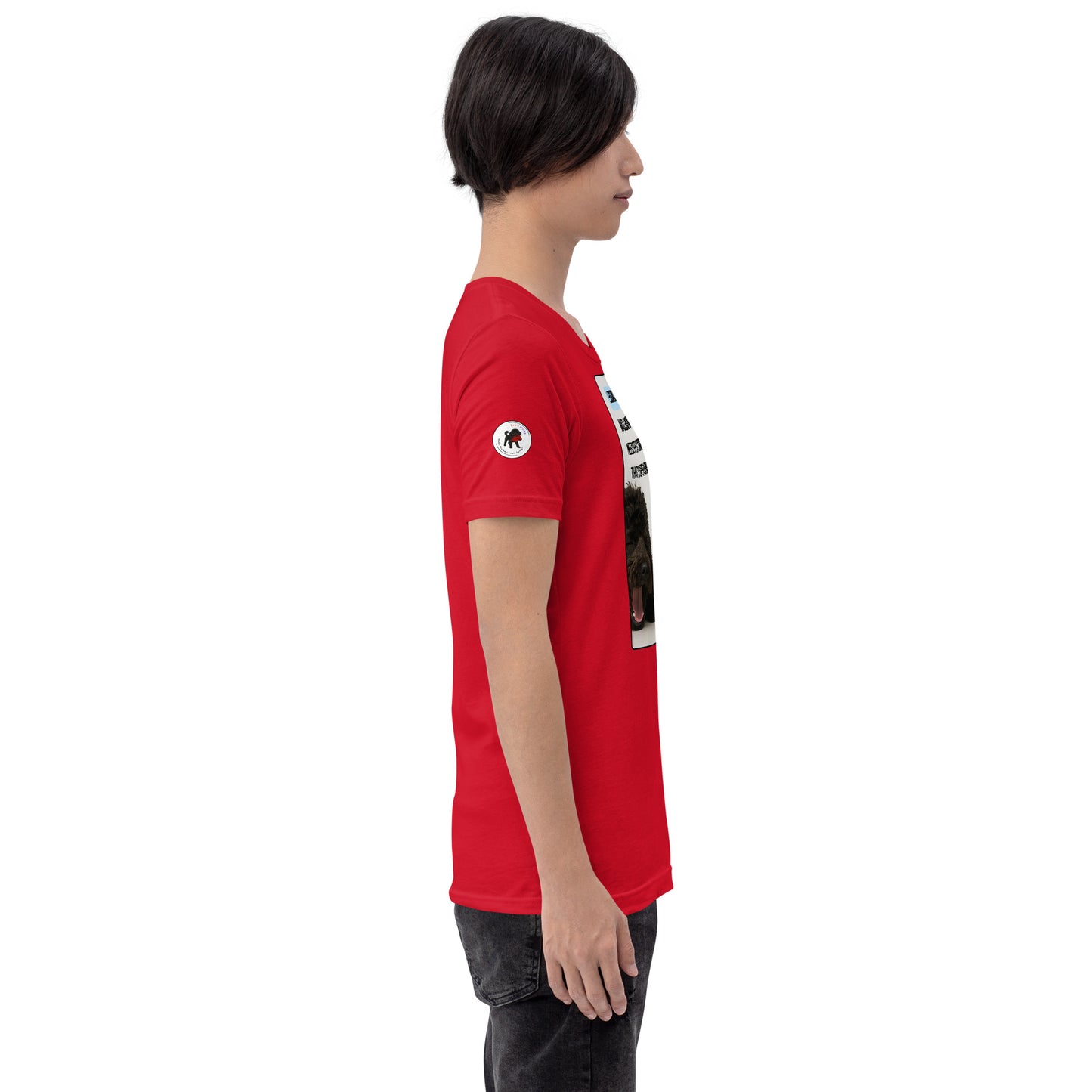 Young man in red t-shirt facing right.  White circular logo on right sleeve.