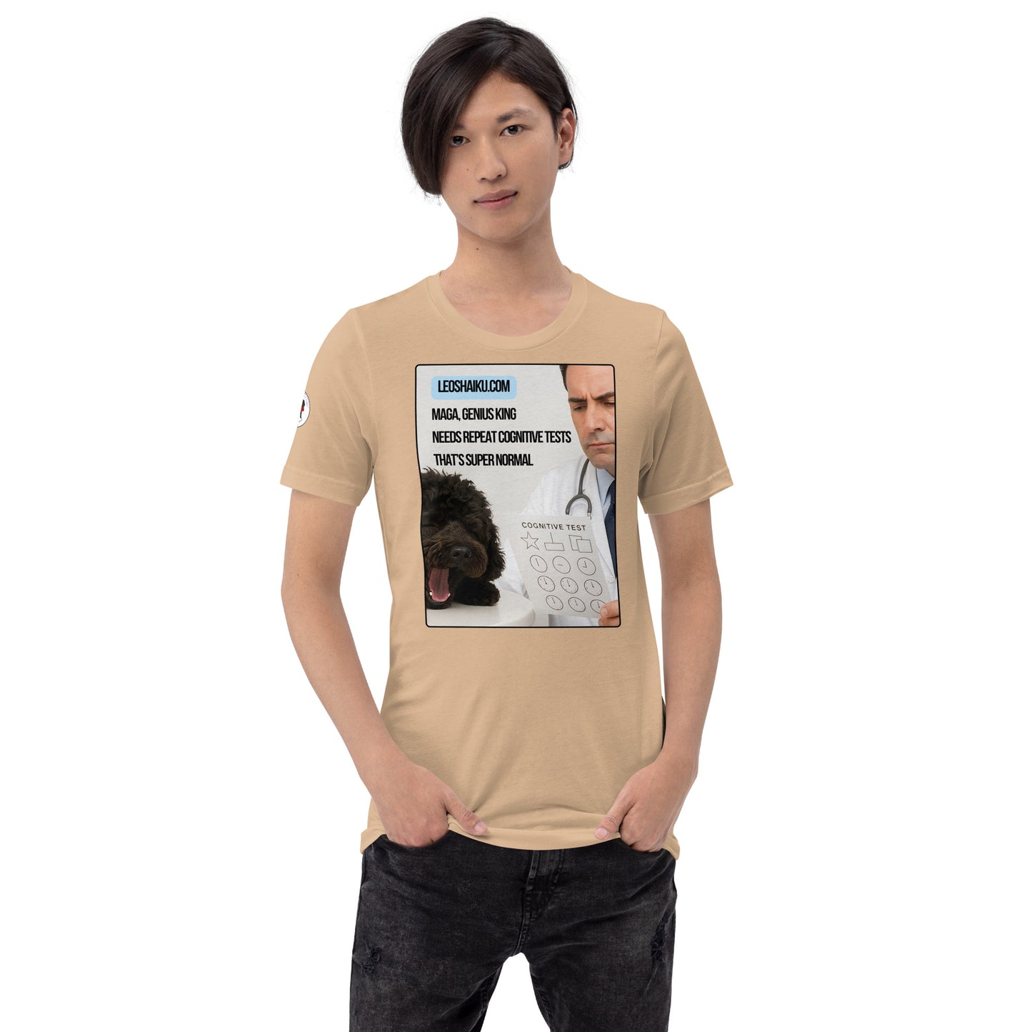 Young man, facing front in tan t-shirt and black jeans.  Shirt is printed with the image of a small black dog asleep on an exam table in front of a doctor holding a cognitive test.  A political, satirical, anti-MAGA Haiku reads:
MAGA, Genius King
Needs Repeat Cognitive Tests
That's Super Normal.
Center above it says leoshaiku.com in black letters on a blue background.