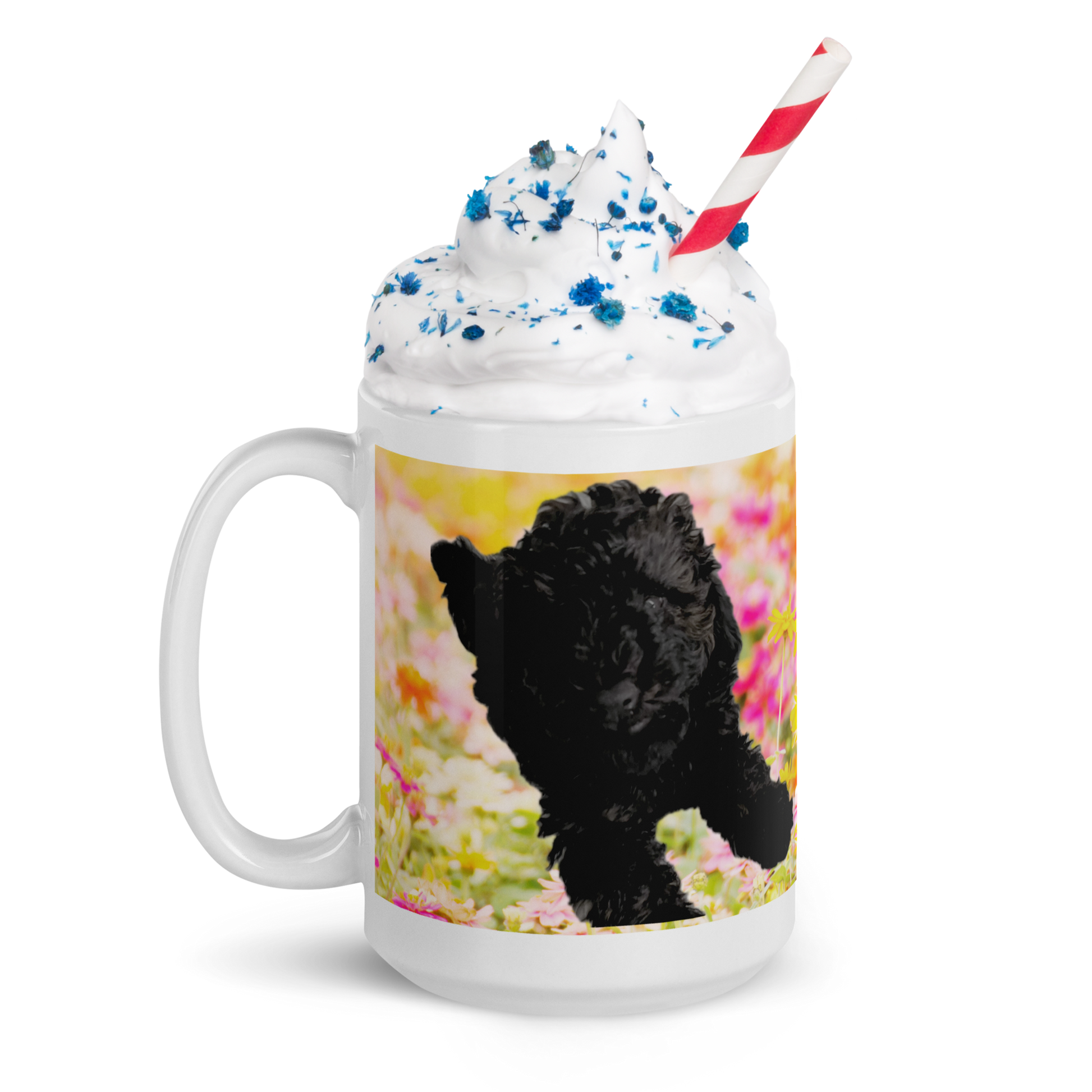 15 oz white ceramic mug, handle on the left.  Printed with bright pink and yellow flowers and a poodle.  Mug contains whip cream with blue sprinkles and a red and white striped straw.