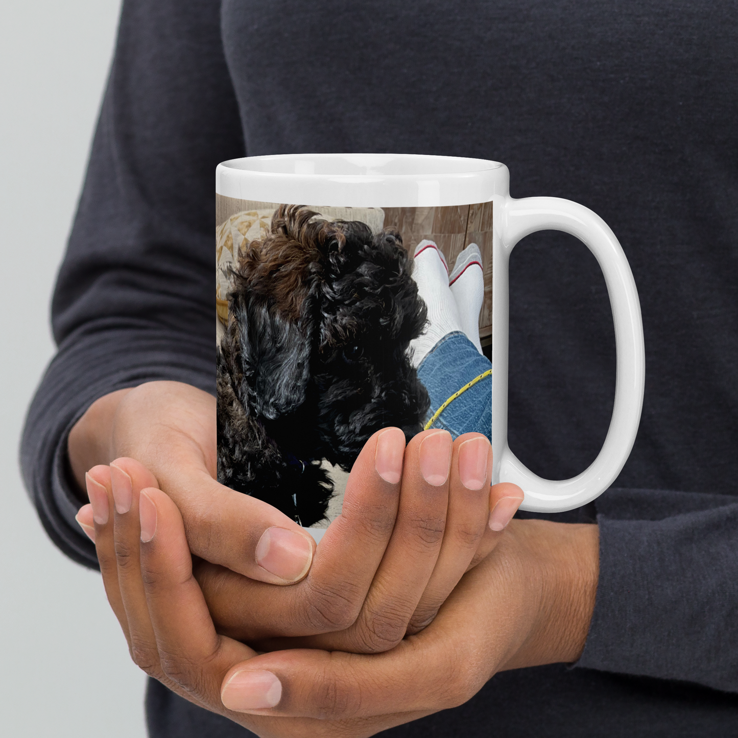 Man holds the 15 oz white glossy mug, handle on the right.  Poodle showing.  Political satire haiku not visible in this view.